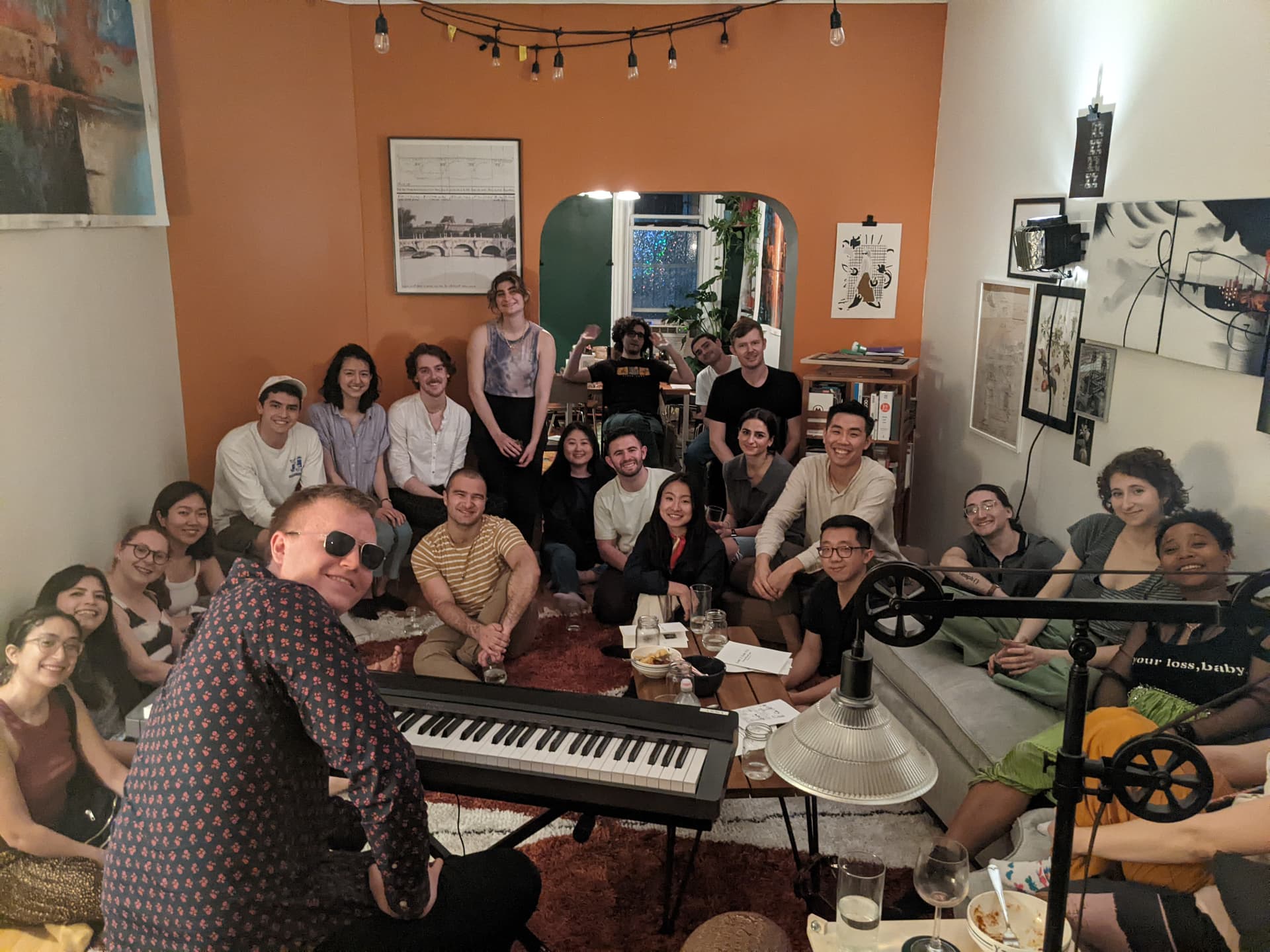 A packed living room at a 1+1 dinner party