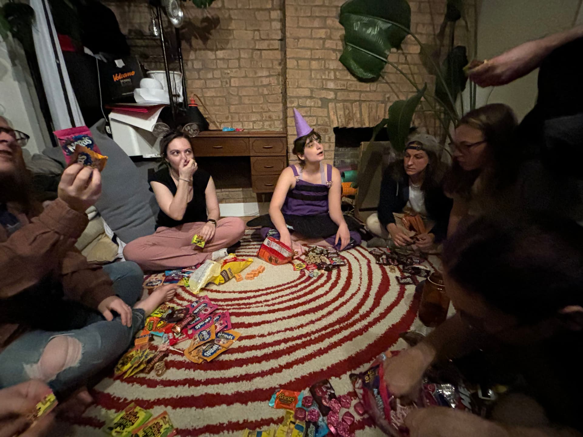 Sitting in a circle on the floor with Halloween candy